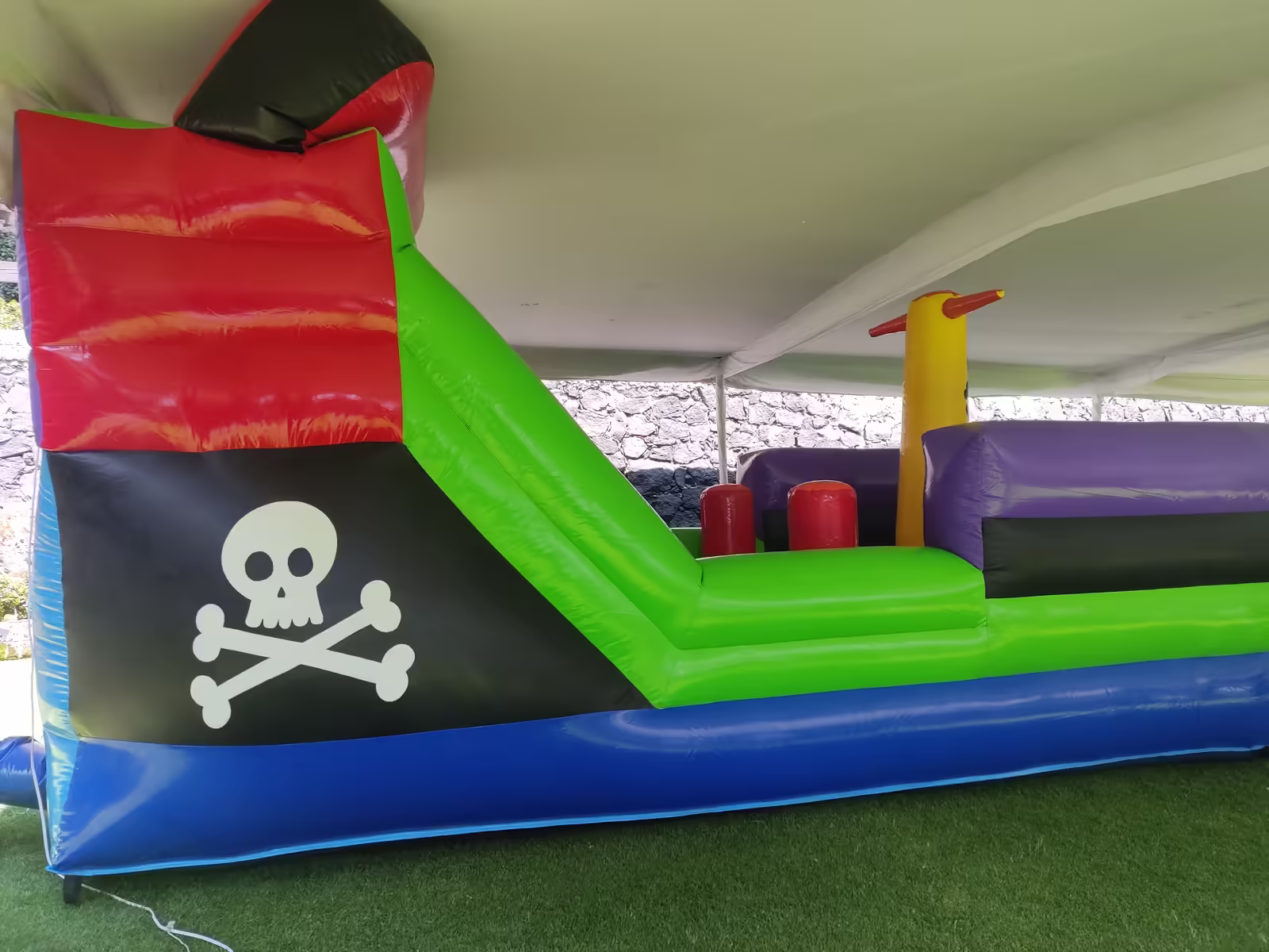 Inflable Barco Pirata con tobogán instalado bajo carpa en un jardín de la Ciudad de México